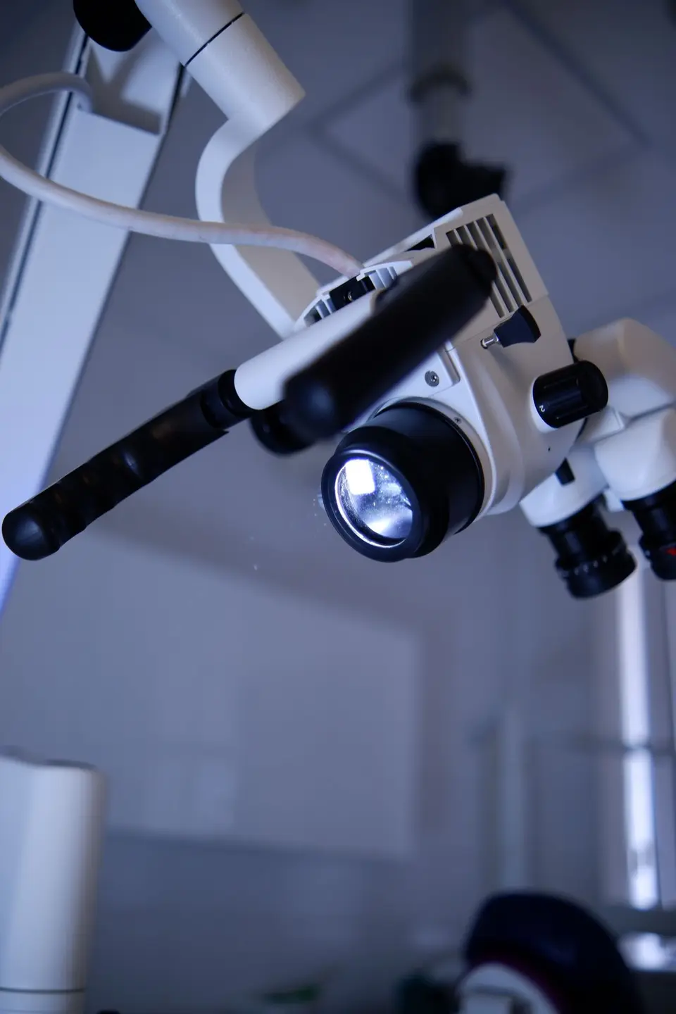 Detailed view of a dental microscope in a modern clinic setting